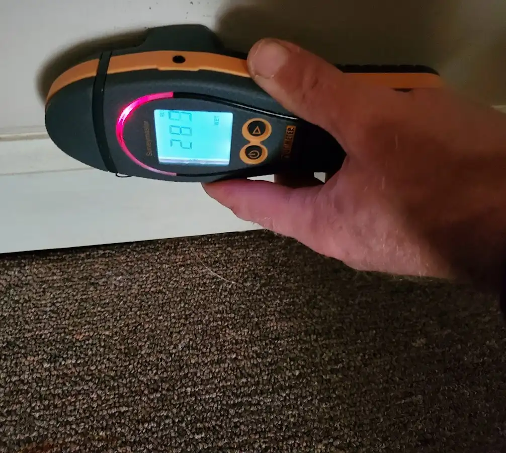 Moisture detection at baseboard during Storm Damage Restoration in North Logan